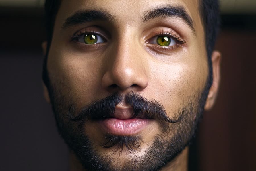 man with green eyes and mustache