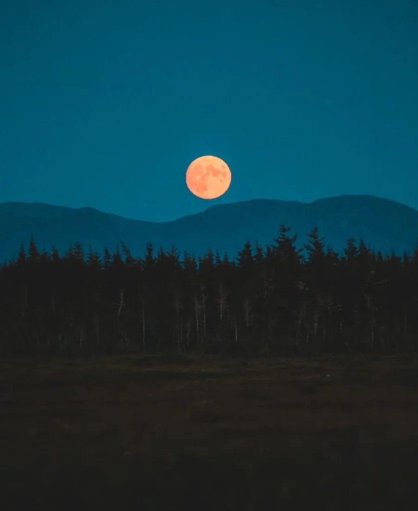orange moon behind the mountain