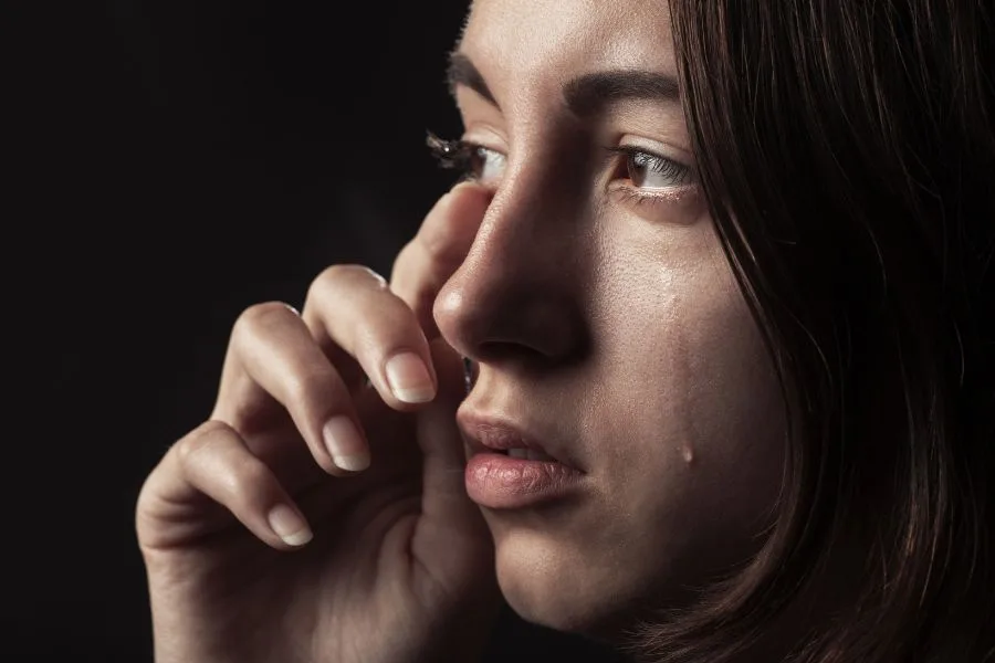 woman crying after waking up