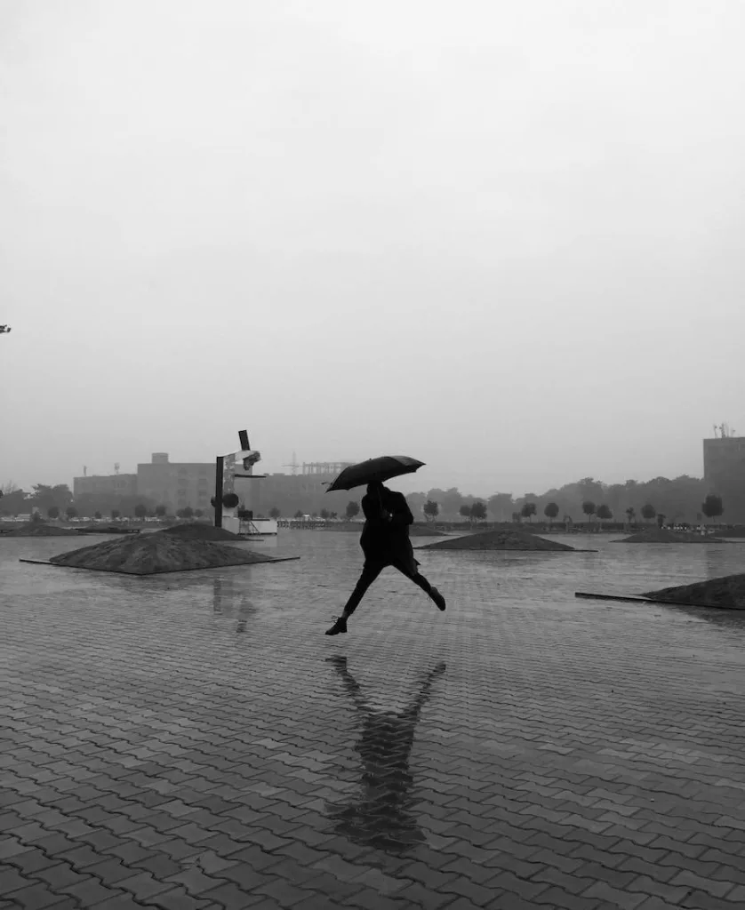 Person jumping in the rain