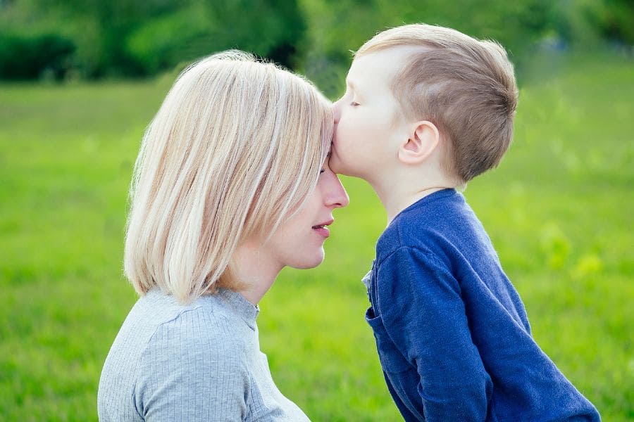 child kissing forehead