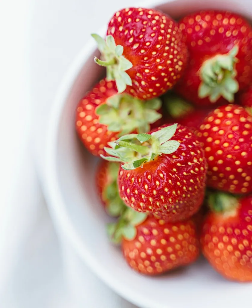 several strawberries inside the pot
