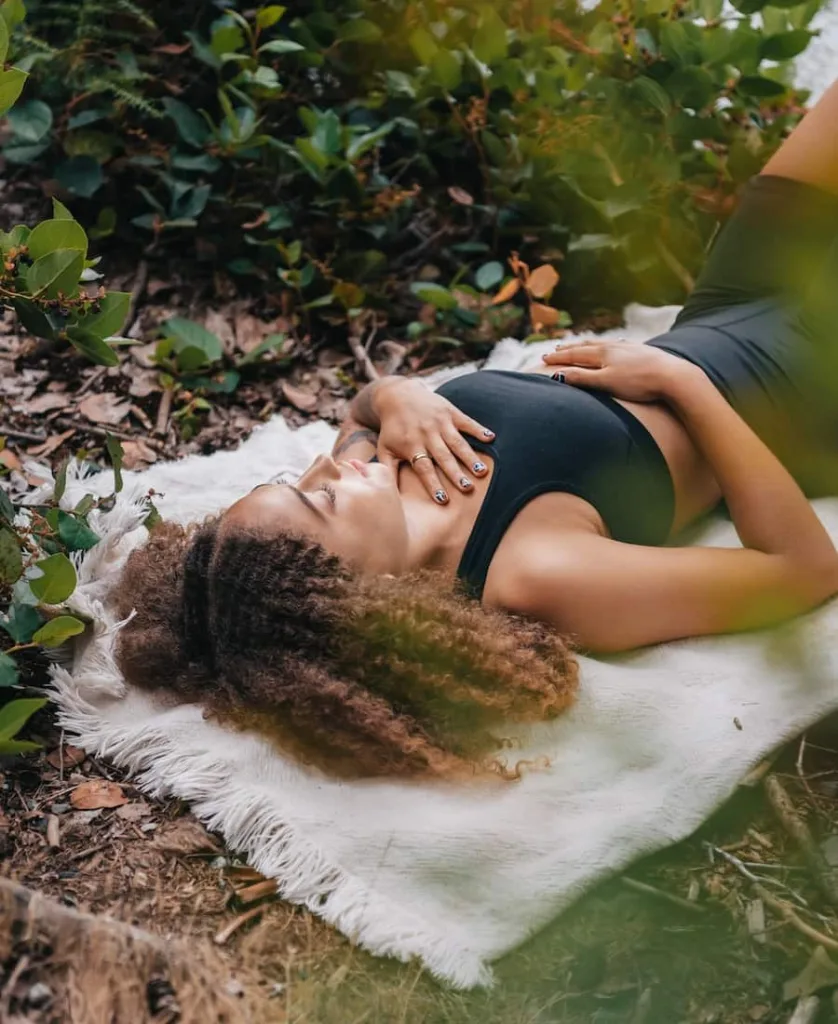 a woman lying down while doing meditation
