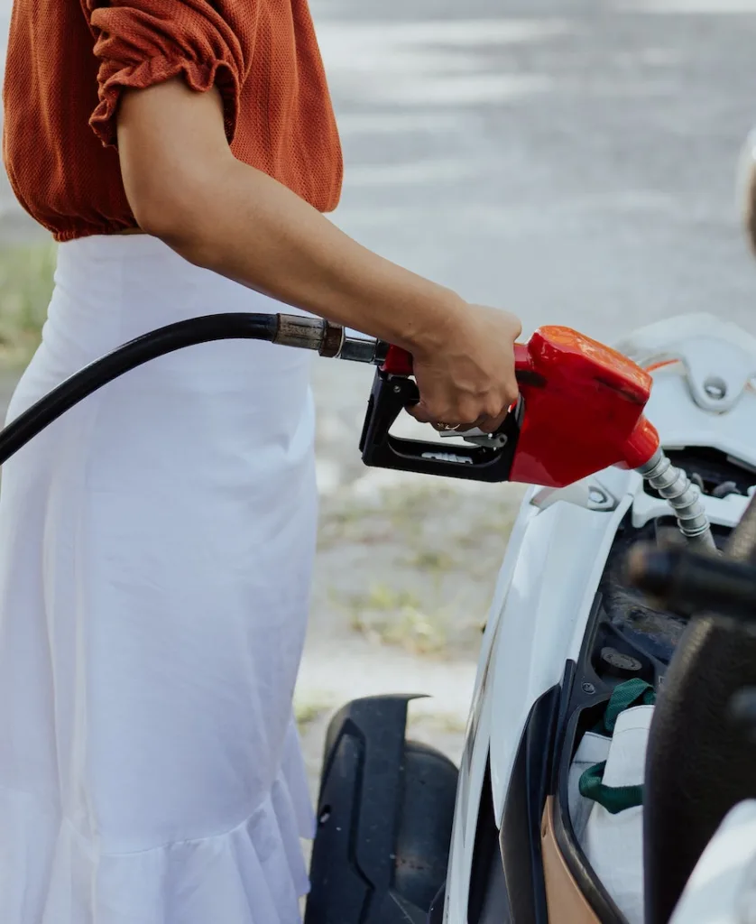 woman filling the car with gasoline