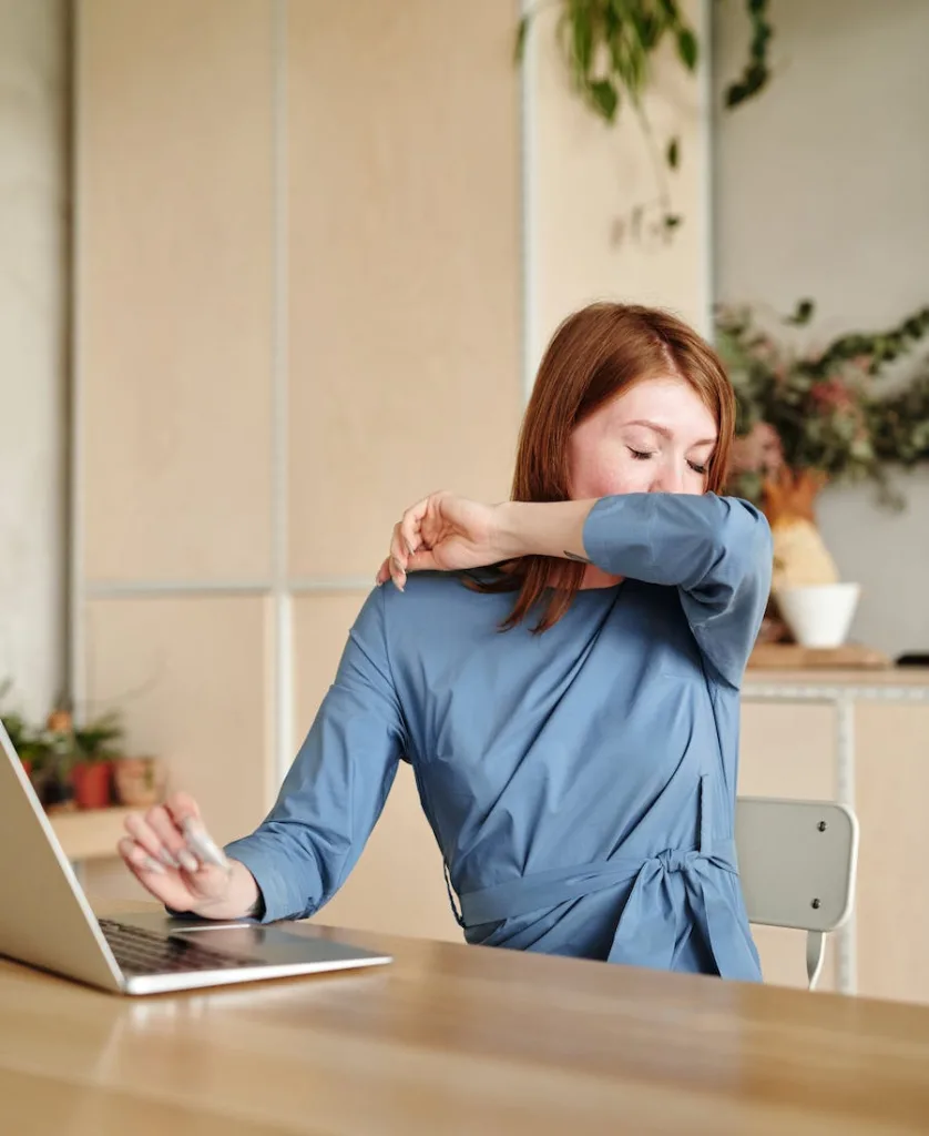 a woman scratching her nose with her arm