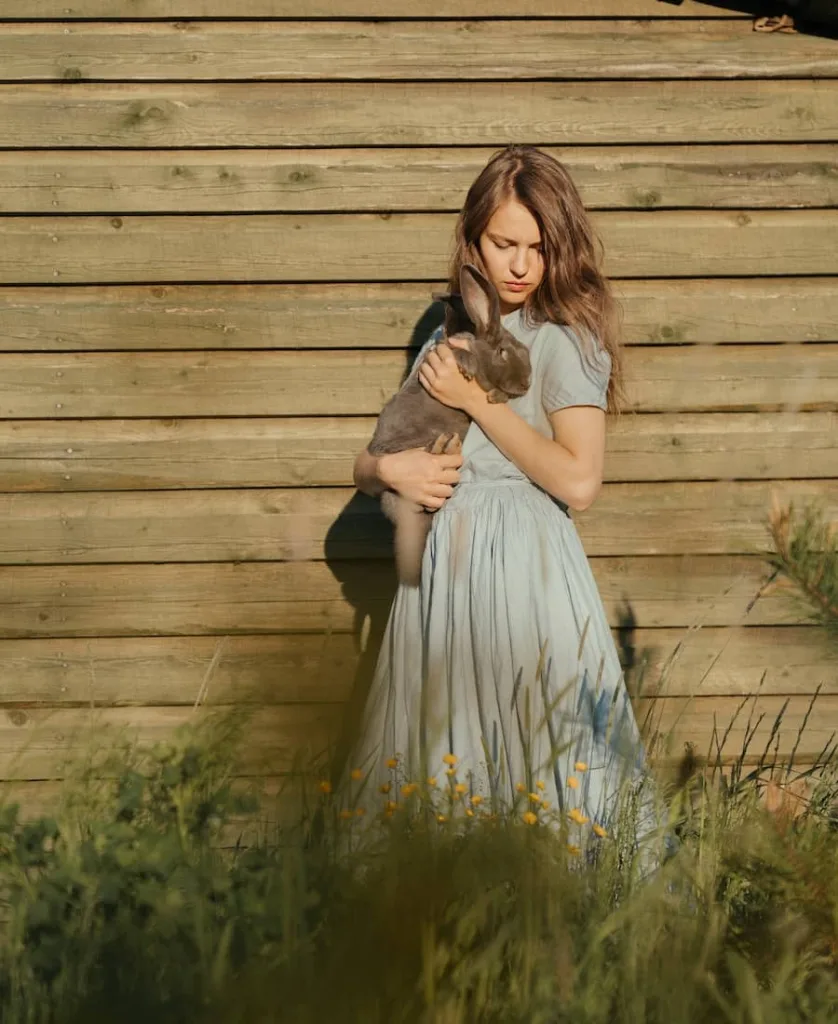 Alice in Wonderland holding a rabbit