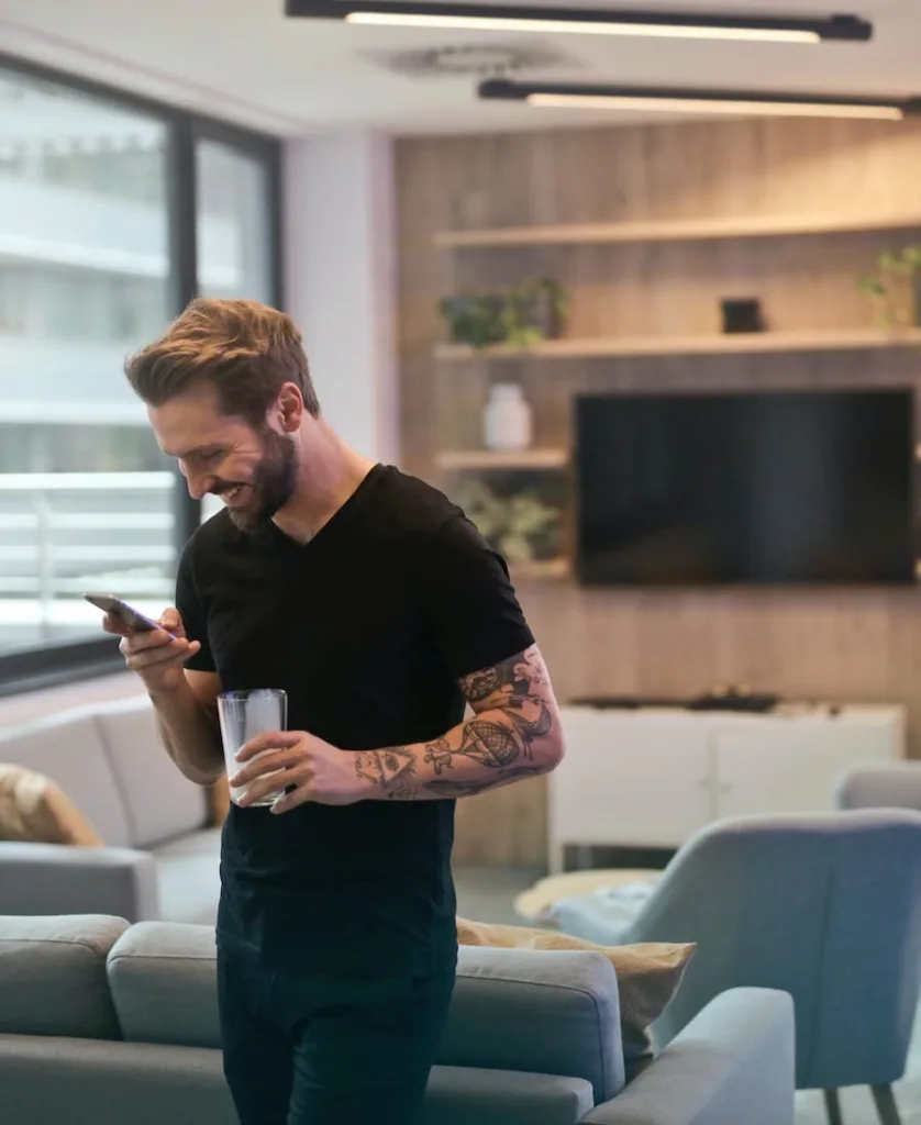 Man using a mobile phone in a living room